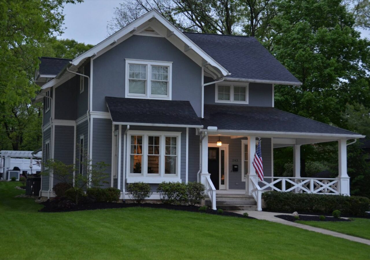 Rain gutter and downspout on a shingled roofline