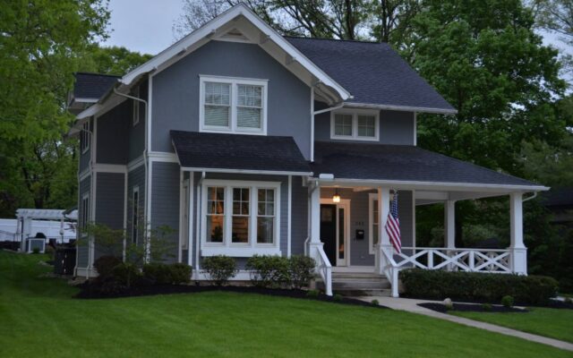 Rain gutter and downspout on a shingled roofline