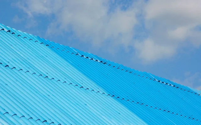 Light blue corrugated metal roof beneath a cloudy sky